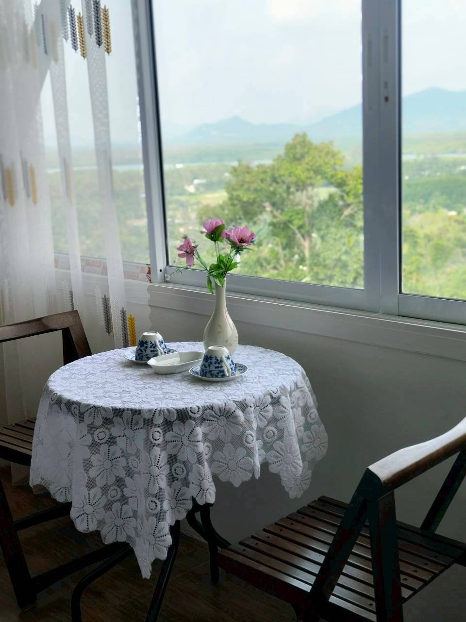 Room sitting area with flowers and a mountain view through the window