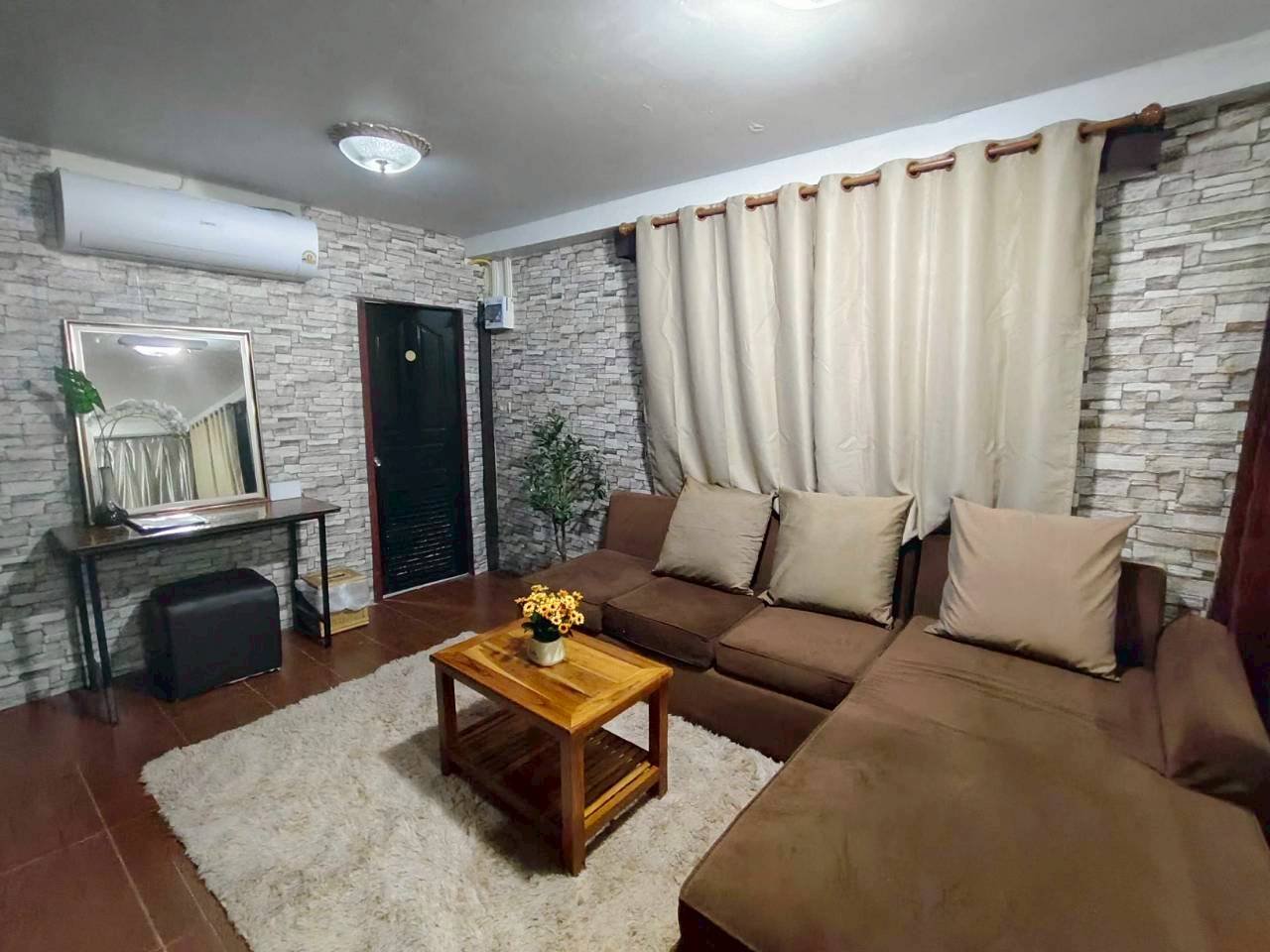 Comfortable family suite sitting area with sofa and warm details